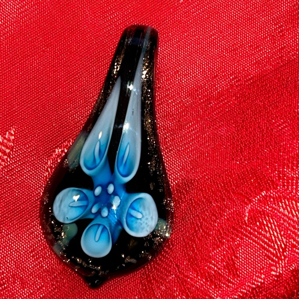 Hand blown glass pendant with blue flower never worn